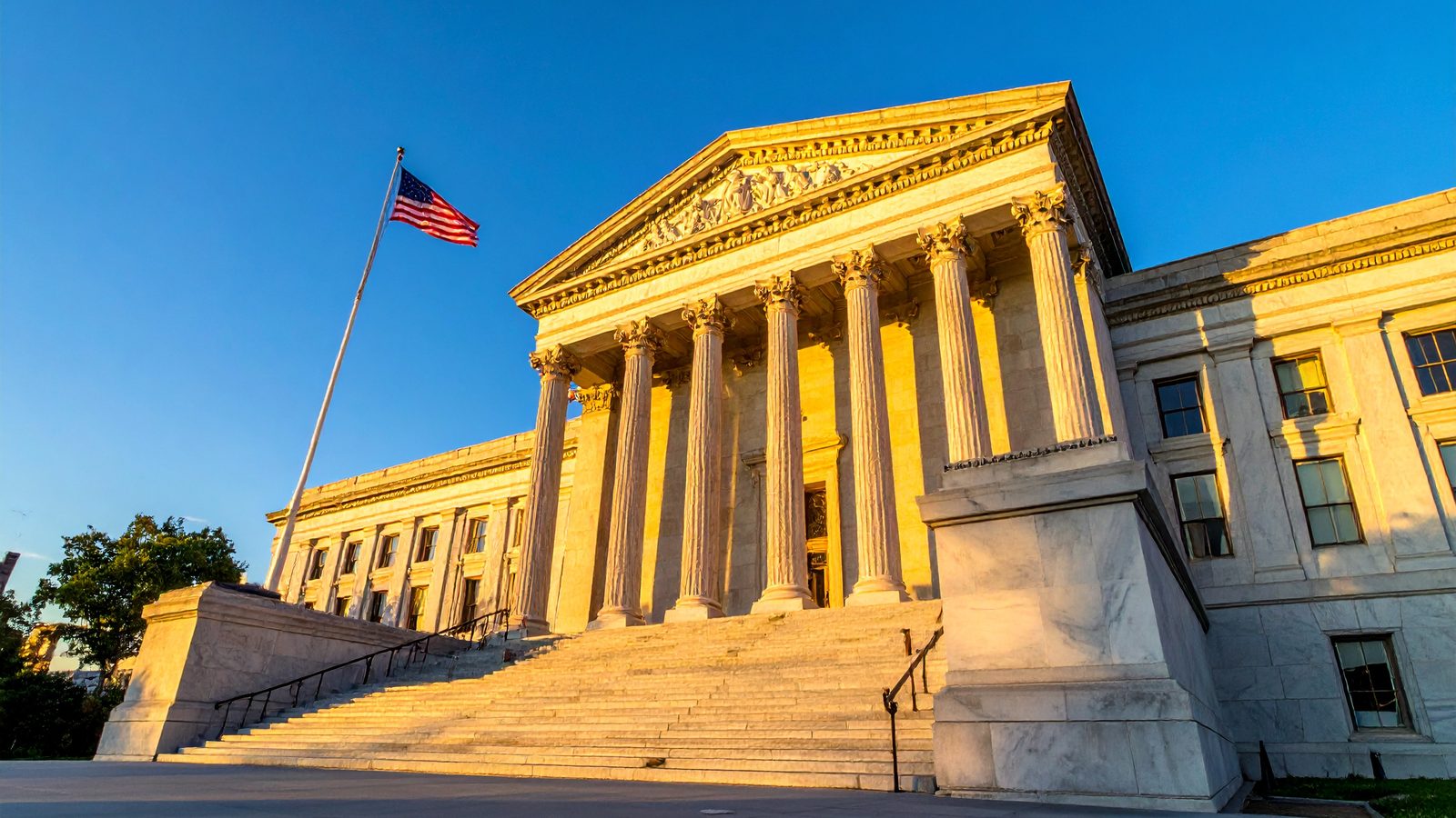 Federal courthouse with marble columns at golden hour, representing Section 1983 federal civil rights claims