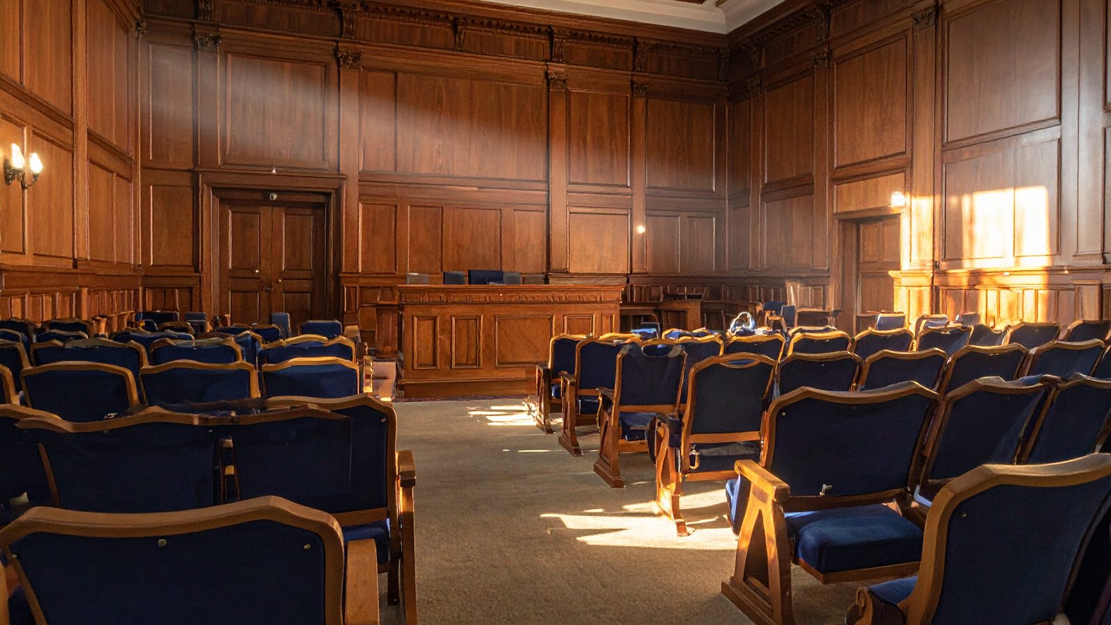 Empty wood-paneled university hearing room, representing the Title IX hearing process