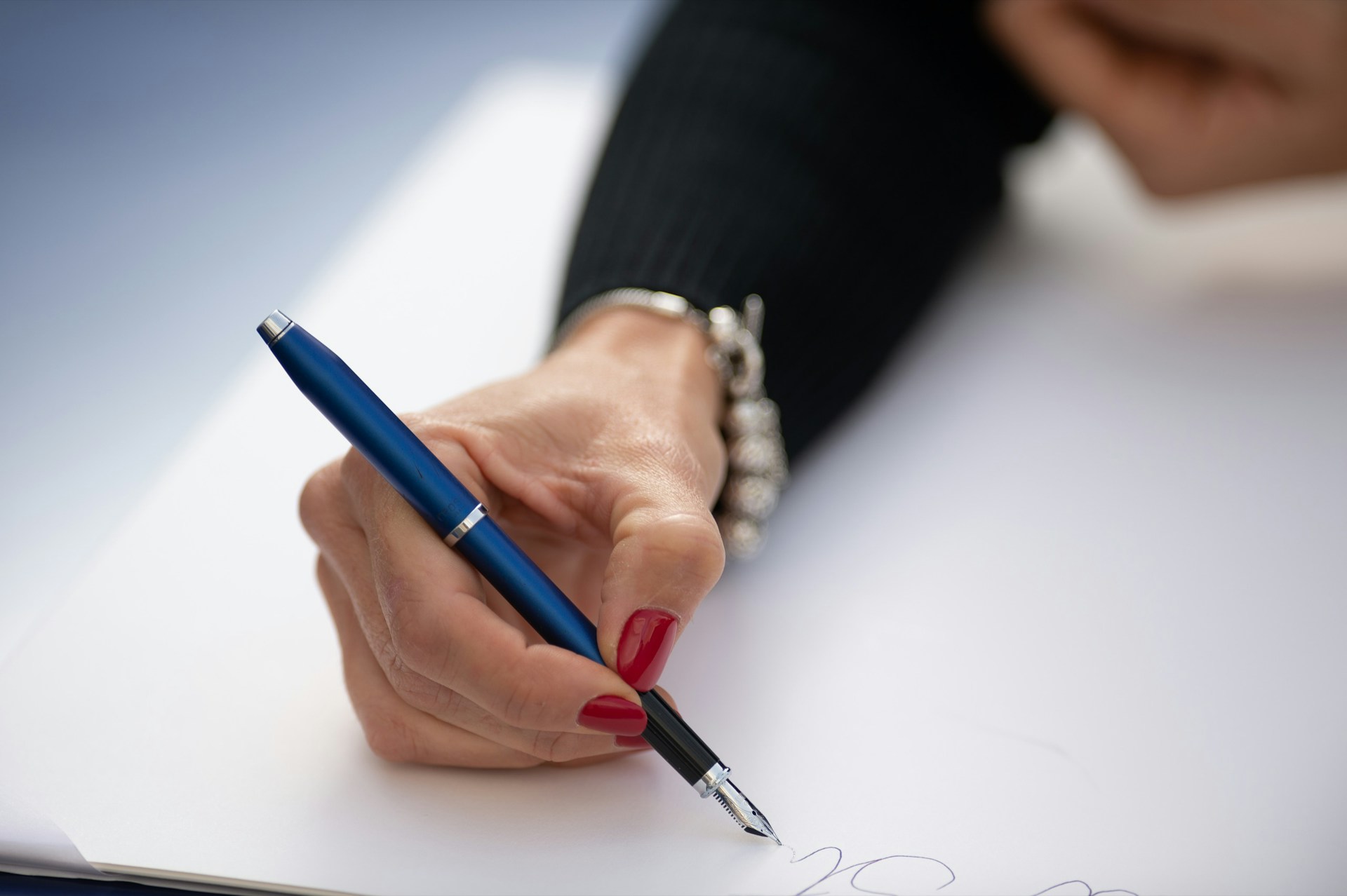 Hand signing a non-compete agreement